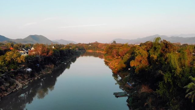 Beautiful sunset over in Luang prabang, Laos. The Nam Kahn River, a tributary of the Mekong River. quadcopter, flying, movement, motion, 4K move drone