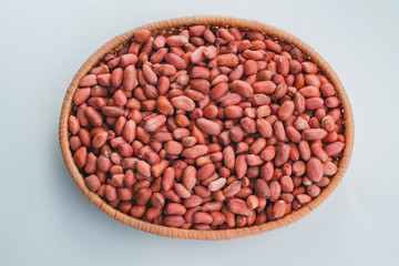  Peanuts in a plate on a white background. A lot of peanuts grains, a lot of nuts.