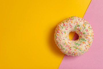 donut on pink and yellow background
