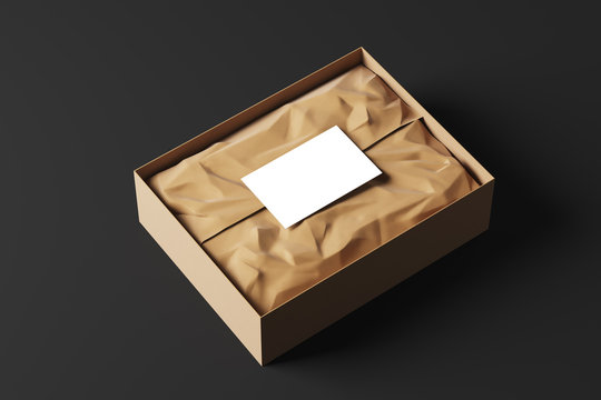 Realistic open cardboard box with white wrapping paper and a business card on a black background. Side view. Mock up. 3d rendering