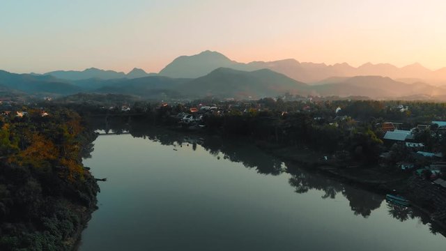 Beautiful sunset over in Luang prabang, Laos. The Nam Kahn River, a tributary of the Mekong River, quadcopter, flying, movement, motion, 4K move drone