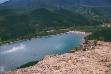 A look from the cliff face of Rattlesnake Trail to a view of the forest valley below, featuring Rattlesnake Lake 