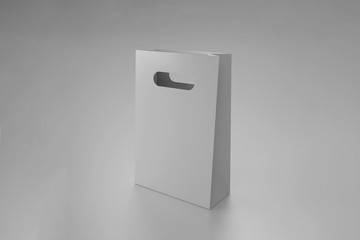 White paper bag mock up with handles on gray background. High resolution.