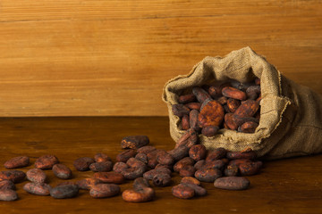 Cacao beans on wooden bacground.