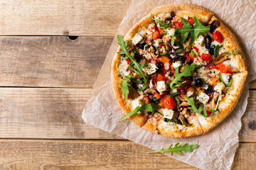 Vegetable italian pizza with tomatos on wodeen background