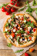 Vegetable italian pizza with tomatos on wodeen background