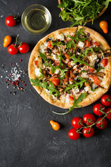 Vegetable italian pizza with tomatos on black background
