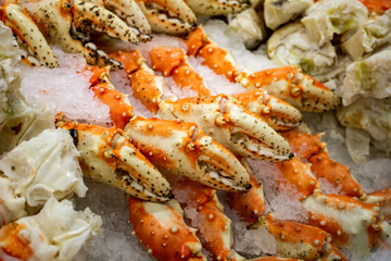 Several units of king crab claws over ice