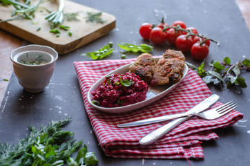 Healthy dinner with fried liver and beet salad. Served with vegetables and greens. Diet, proper nutrition food
