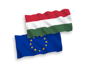 National vector fabric wave flags of Hungary and European Union isolated on white background. 1 to 2 proportion.