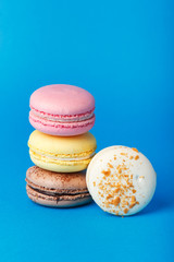 A row of multicolored almond cookies. Macaroons.