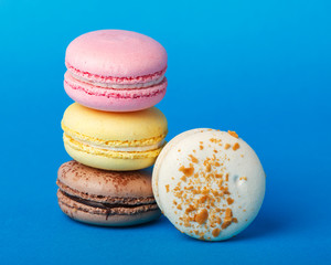 A row of multicolored almond cookies. Macaroons.