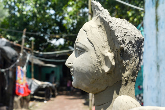 Close up Art model of Maa Durga pratima face. Goddess Durga sculpture made of clay during famous Durga Pooja Celebration. Taken from potter studio in Kumartuli, Calcutta Kolkata, West Bengal, India.