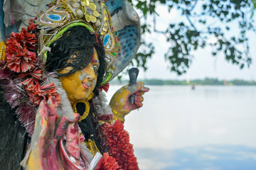A Devi Maa Durga sadly looks down with tousled hair while tears flow the eyes during Durga Maa...