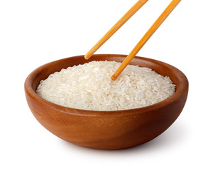 Fototapeta na wymiar A wooden bowl with white rice and food chopsticks. Natural products, healthy food.