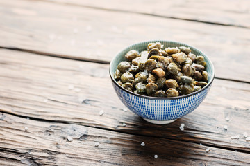 Salt capers on the wooden table