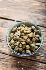Salt capers on the wooden table