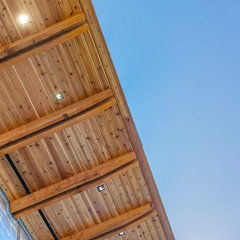 Square The underside of the flat roof of a building with blue sky in the background