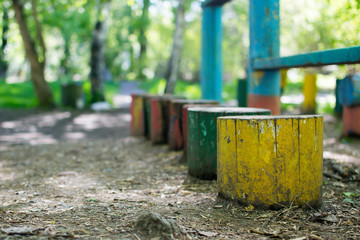 Multicolored stumps in the summer park