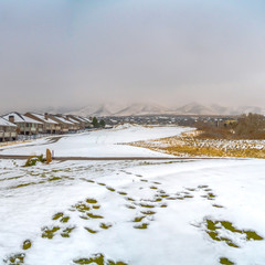 Square Charming houses on a lush valley coated with fresh snow in winter