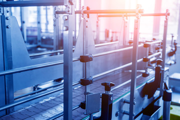 Automatic filling machine pours water into plastic PET bottles. Brewing production.