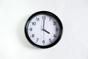 白い壁に掛かった4時の時計