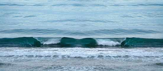 Seascape image of beautiful close up waves in moody rainy morning
