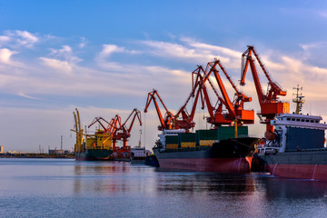Heavy Loader Working in a Harbour in the Background of Sunset