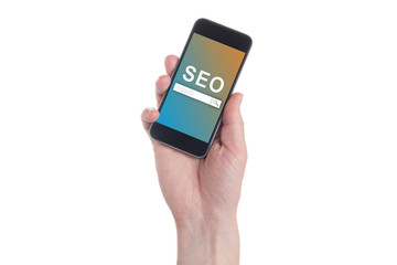 Hand holding black smartphone with text SEO (Search Engine Optimization) on smartphone screen. White backgroun. Seo concept
