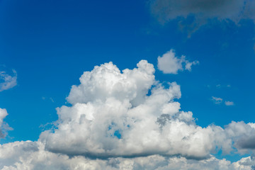 beautiful blue sky with a large cumulus cloud in the foreground