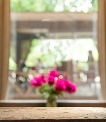Empty of wood table top on blur of curtain with window view green from tree garden background.For montage product display or design key visual layout