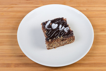 Slice of the layered chocolate sponge cake on white dish