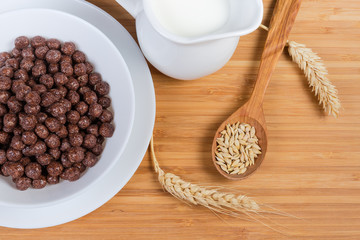 Top view of breakfast cereal chocolate balls and milk closeup
