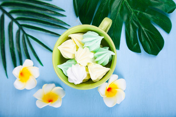 Meringue with tropical leaves and flowers