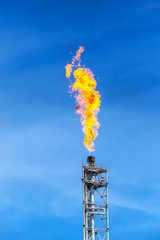 fume of fire on flare stack to burning heat gas, pollution in environment, for power and safety in petrochemical, chemical refinery or power plant in industrial zone, global warming concept