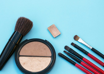 make up brushes cosmetics blue background copy space