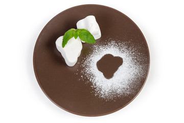 Top view of the white marshmallow on a brown dish