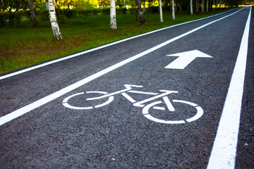Obraz premium Bike path. Sign white paint on the pavement. Summer