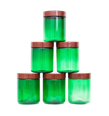 a pyramid of plastic polypropylene green jars on a white background, isolate