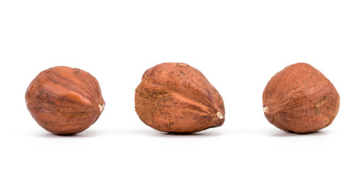 Hazelnuts on a White Background. Three Hazelnuts on a White Background
