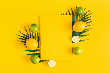 Summer composition. Tropical palm leaves, citrus fruits, yellow paper blank on yellow background. Summer concept. Flat lay, top view, copy space - 271203359