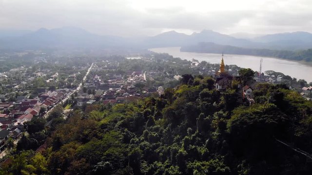 The golden stupa on the top of Mount Phou Si in Luang Prabang, Laos. top view, aerial view. quadcopter, flying, movement, motion, 4K move drone