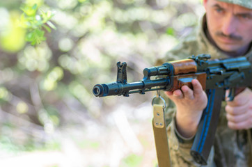 Ukrainian soldier in the battle with a rifle