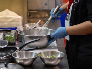 Chef beating food with whisk in a stainless steel bowl. Homemade cooking food