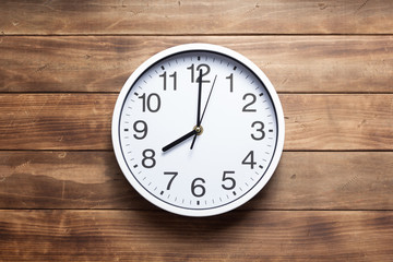wall clock at wooden background