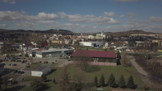 Gorlice, Poland - 4 5 2019: Panorama of the historic center of the European medieval city on the picturesque green hills. Trips to architectural monuments, temples, quarters and sports complex MOSiR