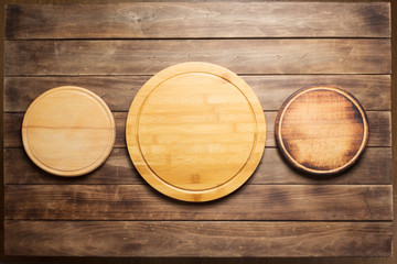 pizza cutting board at wooden plank table