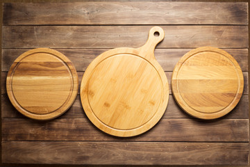 pizza cutting board at wooden plank table