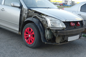 Front of the gray car get damaged in a road accident.