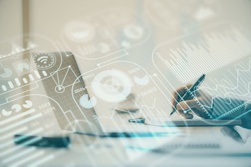 Technology theme hologram with man working on computer on background. High tech concept. Double exposure.